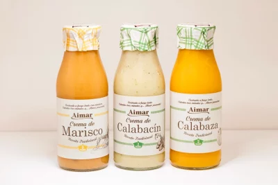"Crema de marisco servida caliente, con un toque de nata y crujientes de pan."