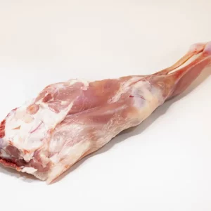 "Pierna de cabrito asada al horno con hierbas aromáticas, mostrando su textura dorada y jugosa."