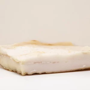Tocino blanco – Sabor y jugosidad en cada bocado "Porción de tocino blanco fresca, mostrando su textura veteada y su color natural."