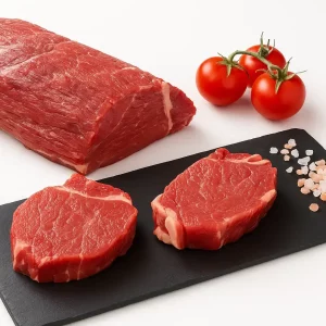 Solomillo de ternera Aluju: sabor, ternura y distinción en cada corte Solomillo de ternera Aluju crudo sobre fondo blanco, acompañado de perejil fresco, mostrando su color rosado, corte limpio y calidad premium.